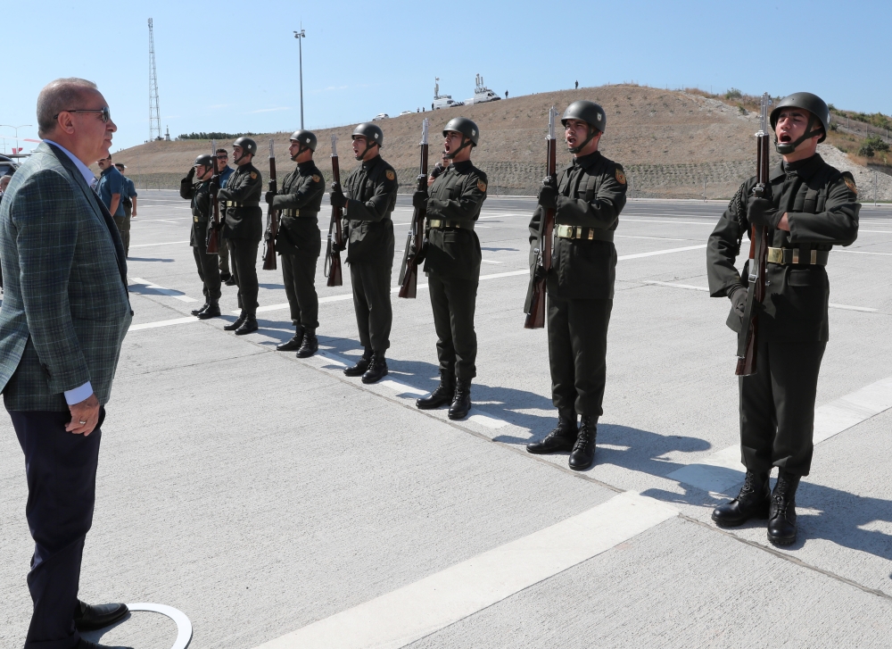 Turkish President Tayyip Erdogan reviews a guard of honour at the airport in Bursa, Turkey,on Sunday. — Reuters