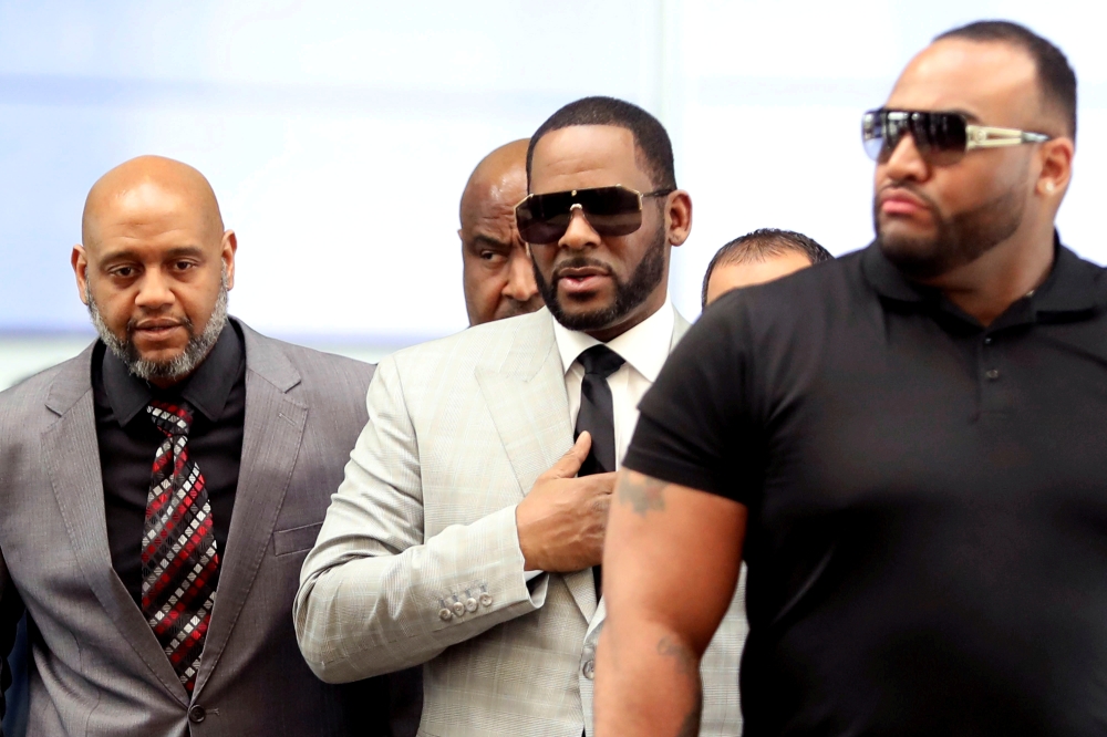 R. Kelly, center, walks inside the Criminal Court Building as he arrives for a hearing on eleven new counts of criminal sexual abuse,  in Chicago, Illinois, in this June 6, 2019 file photo. — Reuters