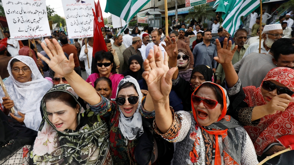 People chant slogans during a rally in Karachi on Tuesday expressing solidarity with the people of Kashmir. — Reuters 