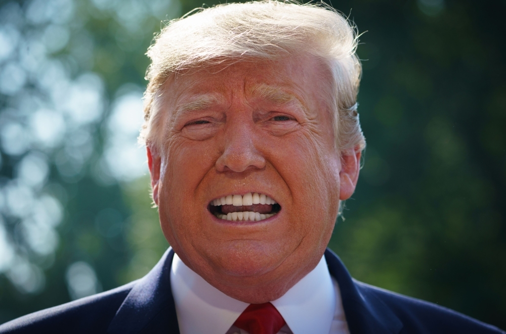 US President Donald Trump speaks to the press as he departs the White House in Washington on Wednesday. — AFP