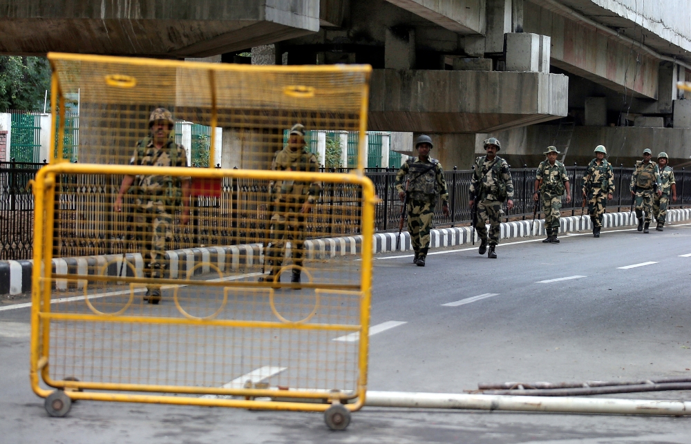 Indian security forces personnel patrol a deserted road during restrictions after the government scrapped special status for Kashmir, in Srinagar, on Wednesday. — Reuters