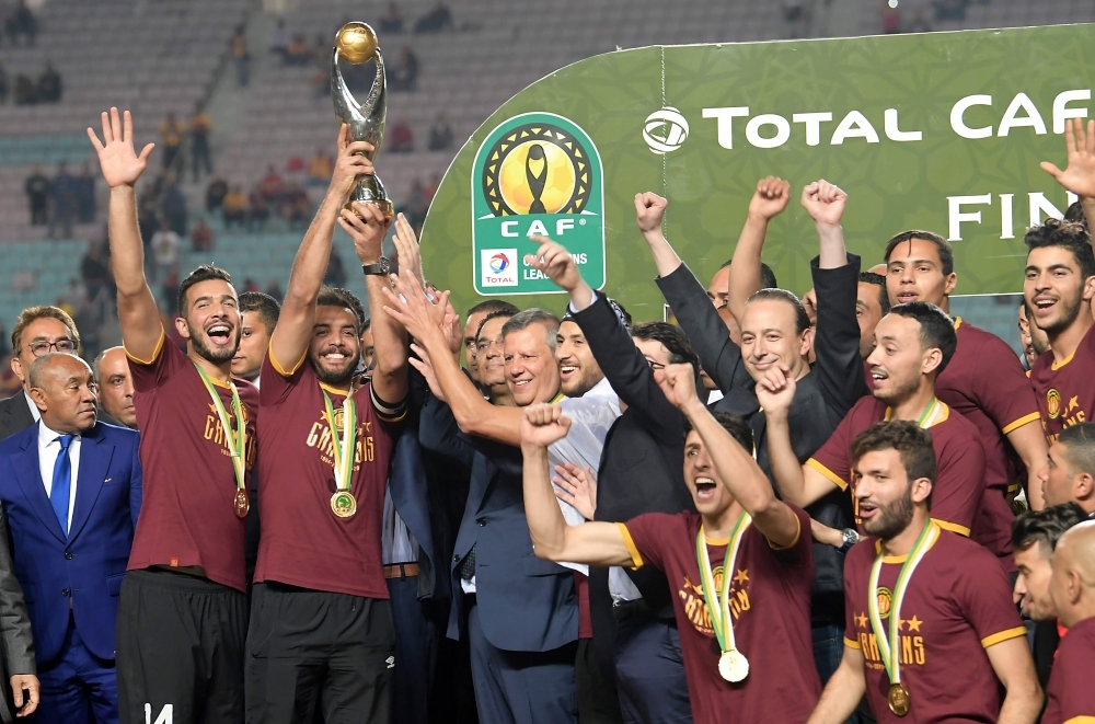 In this file photo taken on May 31, 2019, Esperance de Tunis team captain Moez Ben Cherifia holds a trophy after winning during the 2nd leg of CAF champion league final 2019 football match between Tunisia's Esperance sportive de Tunis and Morocco's Wydad Athletic Club at the Olympic stadium in Rades. Tunisia's Esperance were declared winners of the African Champions League by CAF on Wednesday following a long legal battle after Wydad Casablanca stormed off in protest during the second leg of the final in May. —  AFP