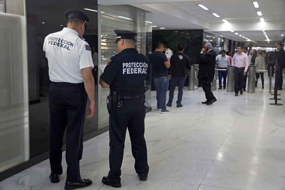 Police officers keep watch during a security operation after armed robbers stole gold coins worth more than $2 million, outside Casa de Moneda in Mexico City, Mexico, on Tuesday. — Reuters