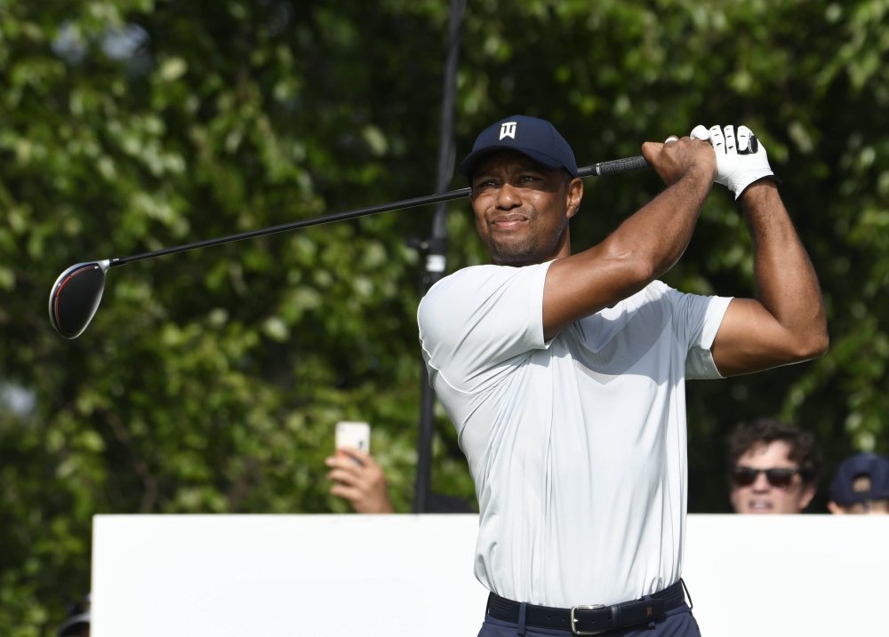  Tiger Woods hits his tee shot on the 17th hole during the first round of The Northern Trust golf tournament at Liberty National Golf Course, in Jersey City, New Jersey on Thursday.  -Reuters