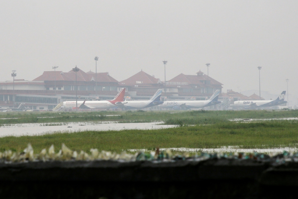 Planes are seen parked inside the flooded Cochin international airport following heavy rain, on the outskirts of Kochi, India on Friday. -Reuters