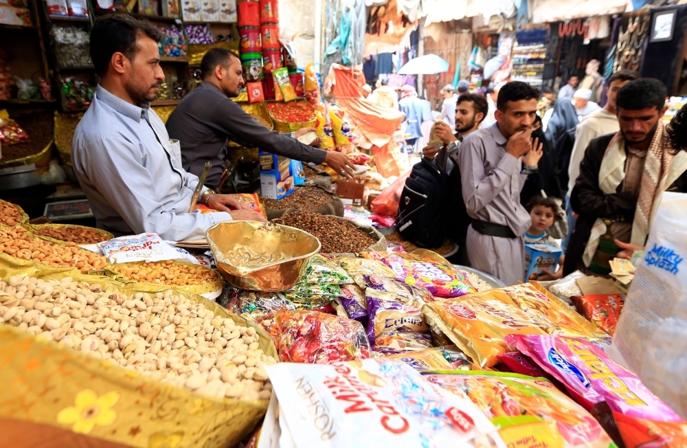 Yemenis buy sweets and nuts at a market in the capital Sanaa on Thursday. — AFP