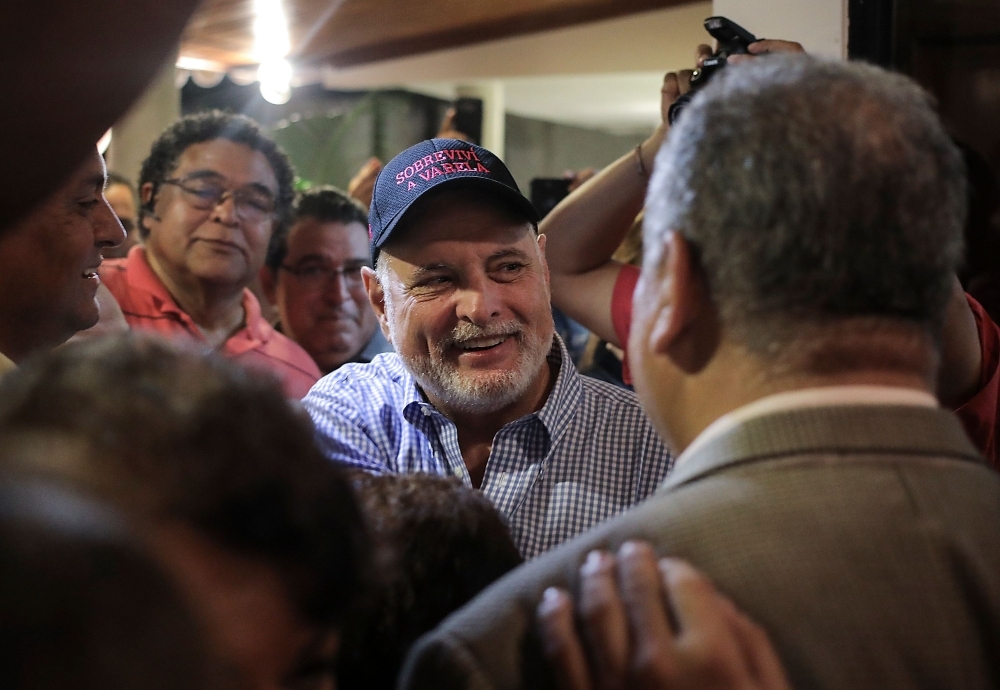 Panama's former President Ricardo Martinelli, center, detained a year ago on illegal wiretapping charges, is welcomed by family and friends at a private party after being declared innocent after being declared innocent in Panama City, on Friday. — AFP