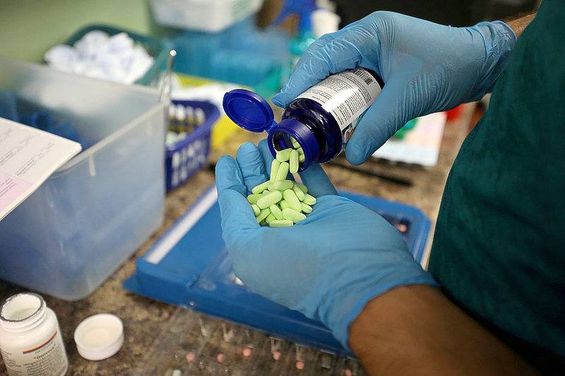A pharmacist counts prescription drugs at the at the Center Town Pharmacy in Ottawa, Ontario, Canada, on June 12. -Reuters