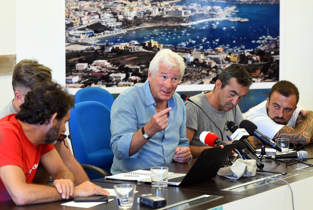 Founder and director of Proactiva Open Arms NGO Oscar Camps, Head of mission of Proactiva Open Arms NGO Riccardo Gatti, US actor Richard Gere and Italian chef Gabriele Rubini (known as Chef Rubio), attend a news conference in support of an NGO ship 