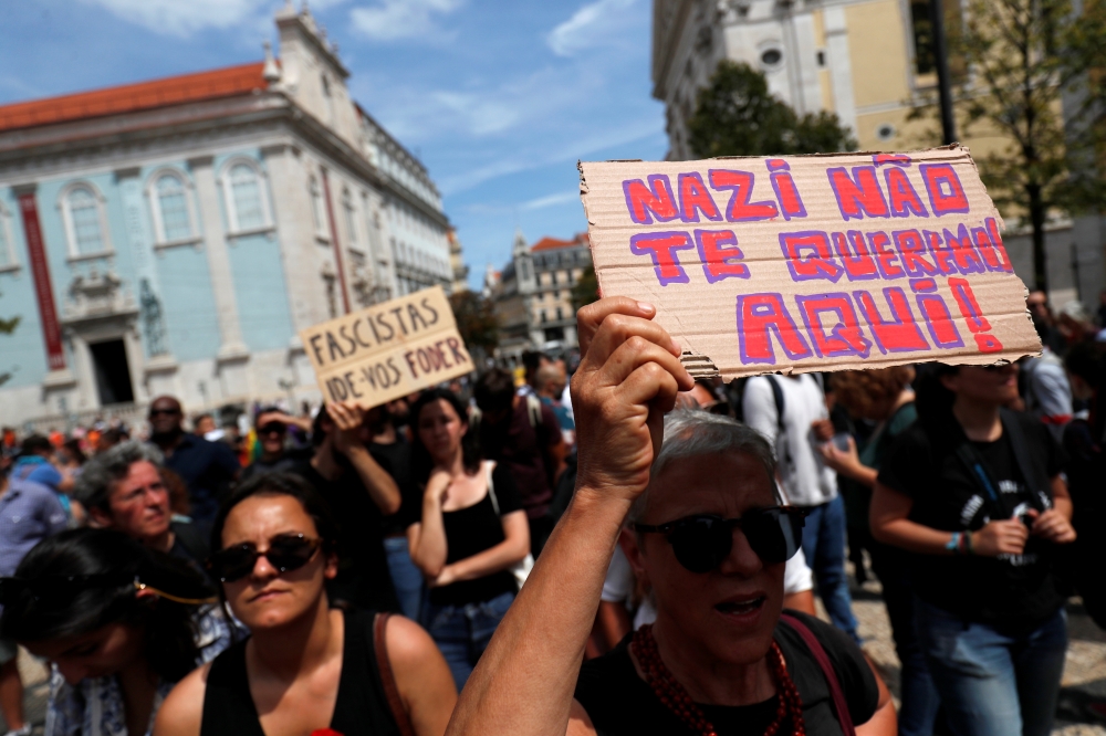 Anti-fascist activists protest against a conference of far-right groups in downtown Lisbon, Portugal on Saturday. The placard reads: 