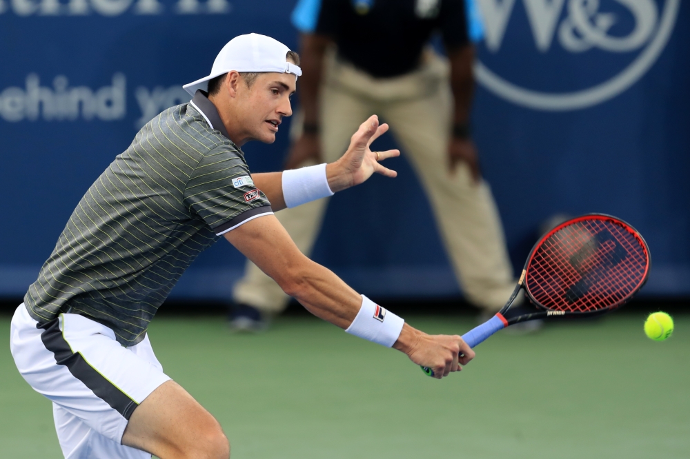 John Isner (USA) returns a shot against Dusan Lajovic (SRB) during the Western and Southern Open tennis tournament at Lindner Family Tennis Center in Mason, Ohio, on Sunday. — Reuters