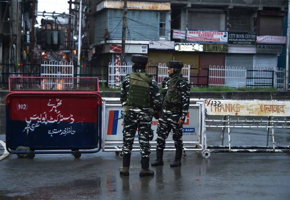 Security personnel stand guard during a lockdown in Srinagar on Wednesday, after the Indian government stripped Jammu and Kashmir of its autonomy. — AFP