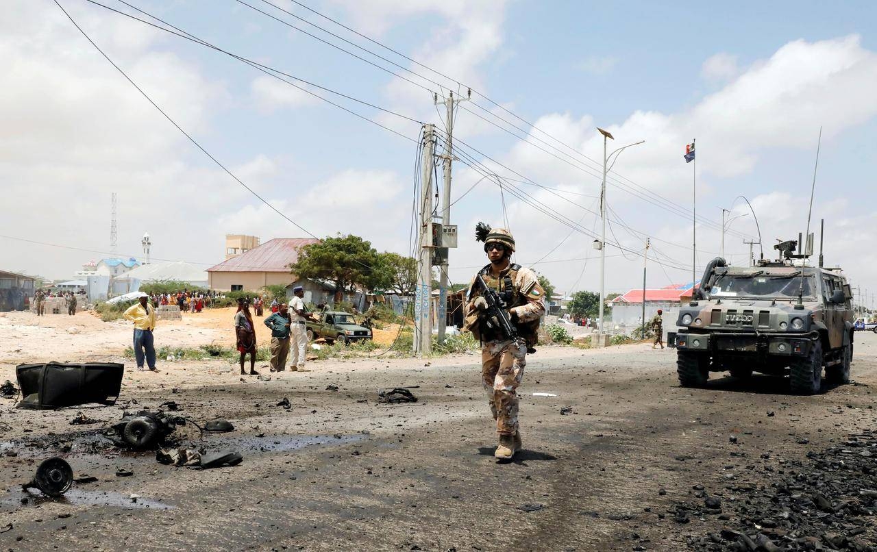 A soldier patrols the road as the damage is assessed after militant group Al-Shabaab hit a European Union armored convoy in Mogadishu, Somalia, in this Oct. 1, 2018 file photo. — Reuters