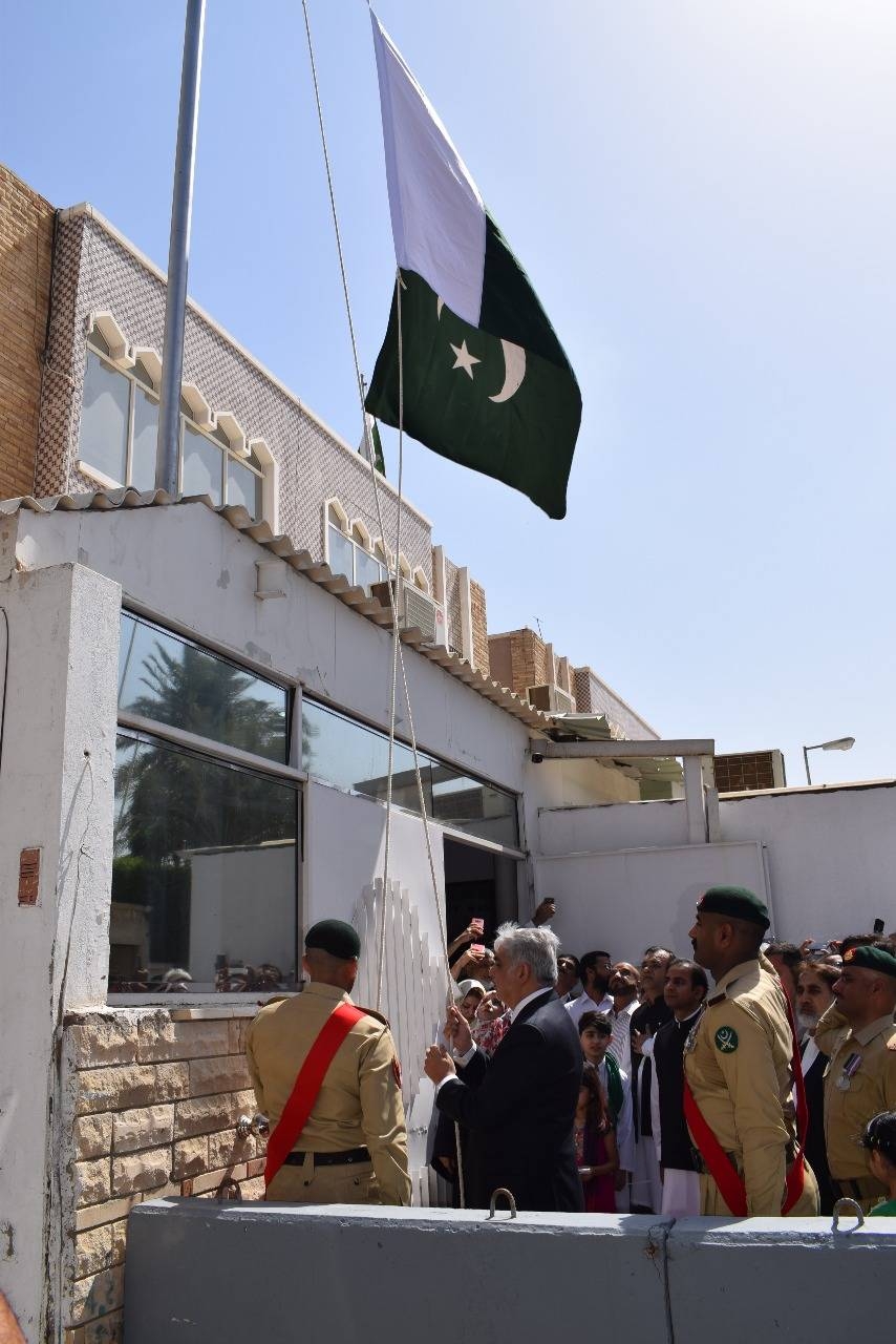 Consul General of Pakistan Shehryar Akbar Khan hoists the Pakistani flag to mark the Independence Day at the premises of the Pakistan Consulate in Jeddah on Wednesday. — Courtesy photo