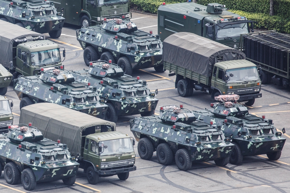 Military vehicles are parked on the grounds of the Shenzhen Bay Sports Center in Shenzhen, China on Thursday.  -Reuters