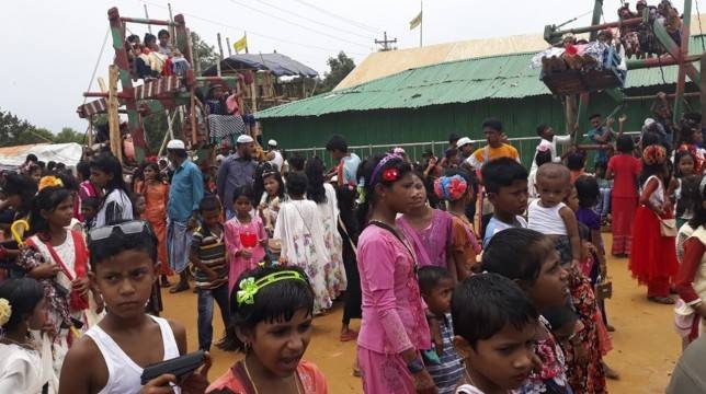 Young Rohingya refugees enjoy ride in a traditional wooden ferris wheel during Eid Al-Fitr festival celebrations at a refugee camp in Ukhia district near Cox's Bazar, Bangladesh, in this June 5, 2019 file photo. — Reuters