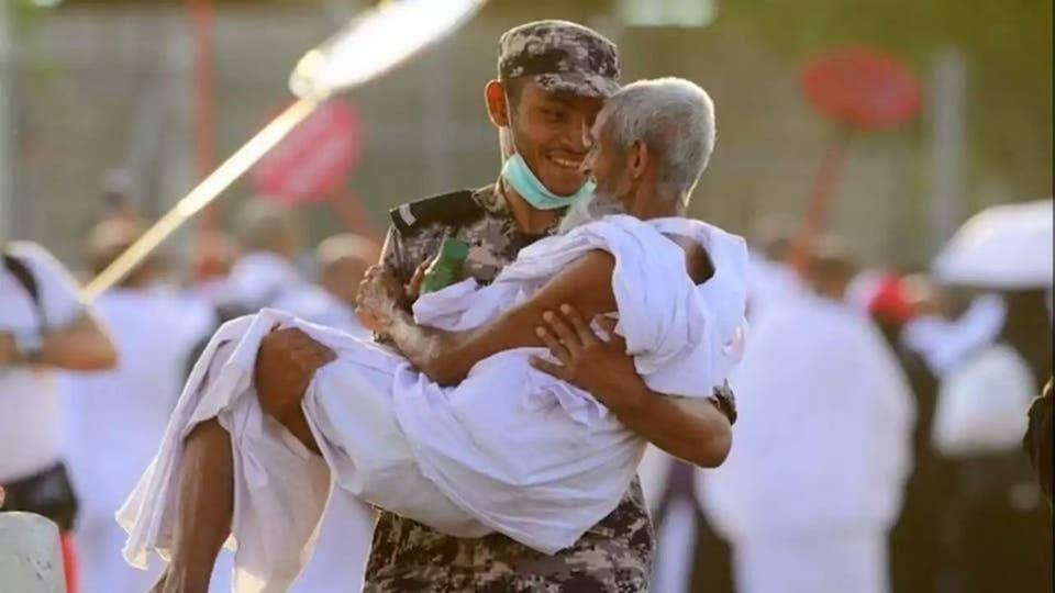 An elderly pilgrim is being carried by a Saudi security man. — SPA