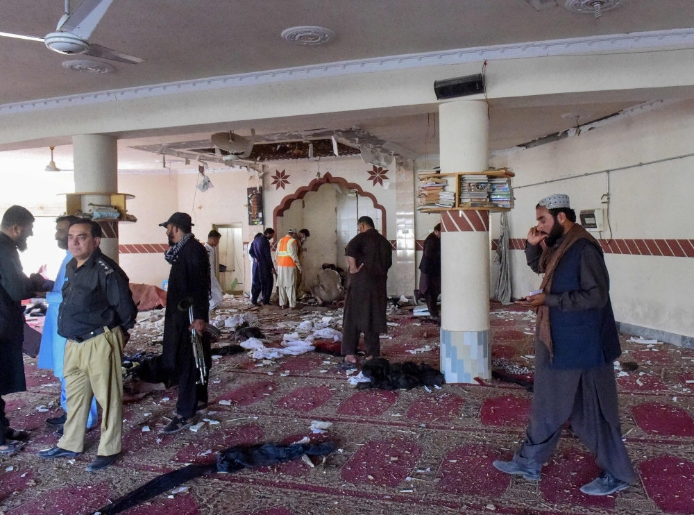 Security officials examine the blast site at a mosque in the town of Kuchlak in southwest Quetta district, Pakistan, on Friday. — AFP