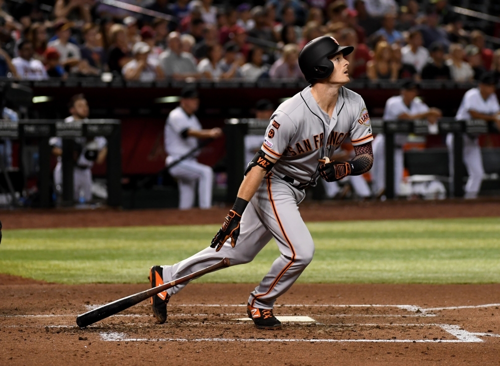 Mike Yastrzemski of the San Francisco Giants hits a solo home run during the third inning against the Arizona Diamondbacks at Chase Field in Phoenix, Arizona, on Friday. — AFP