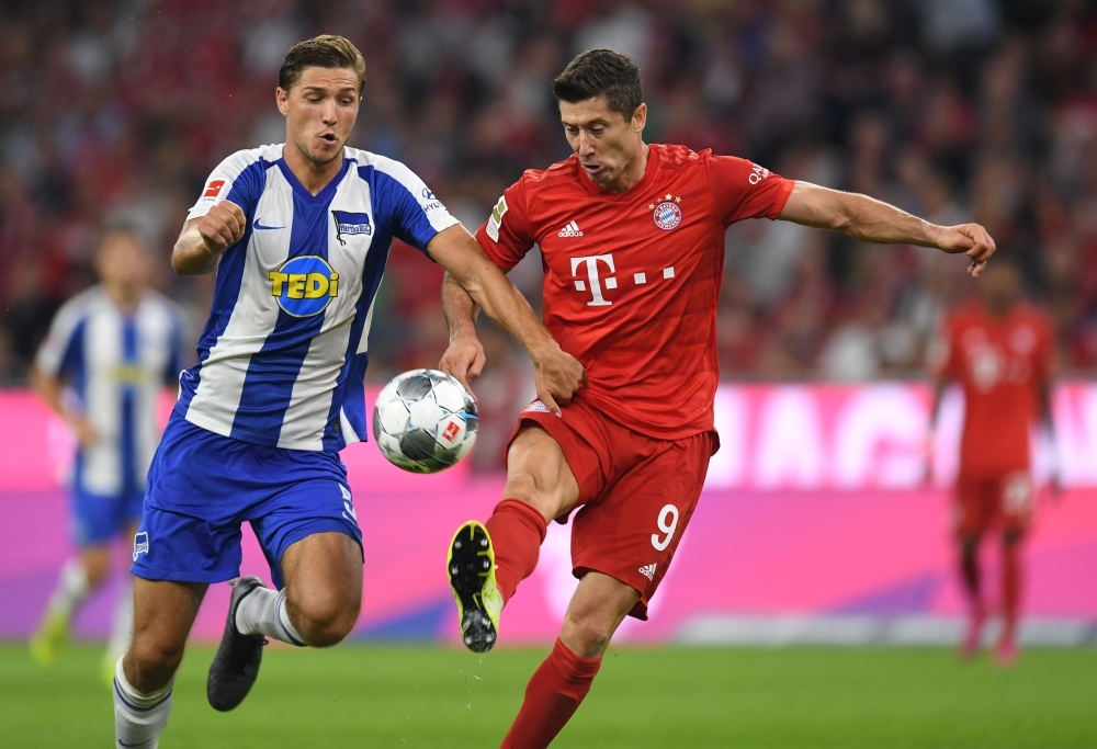 Bayern Munich's Polish striker Robert Lewandowski (R) and Hertha Berlin's German defender Niklas Stark  vie for the ball during the German First division Bundesliga football match FC Bayern Munich v Hertha Berlin in Munich, southern Germany, on Friday. — AFP