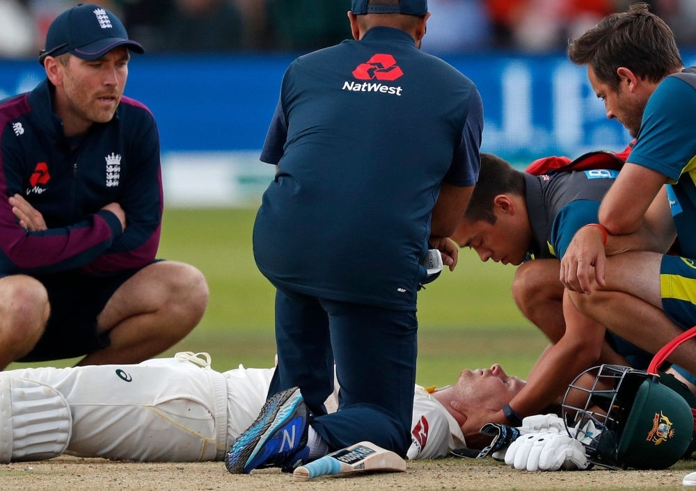 Australia's Steve Smith lays on the pitch after being hit in the head by a ball off the bowling of England's Jofra Archer (unseen) during play on the fourth day of the second Ashes cricket Test match between England and Australia at Lord's Cricket Ground in London, on Saturday. — AFP