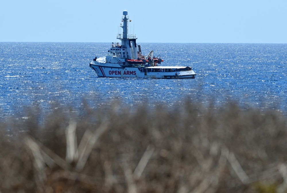 Spanish migrant rescue ship Open Arms is seen close to the Italian shore in Lampedusa, Italy, on Monday. — Reuters