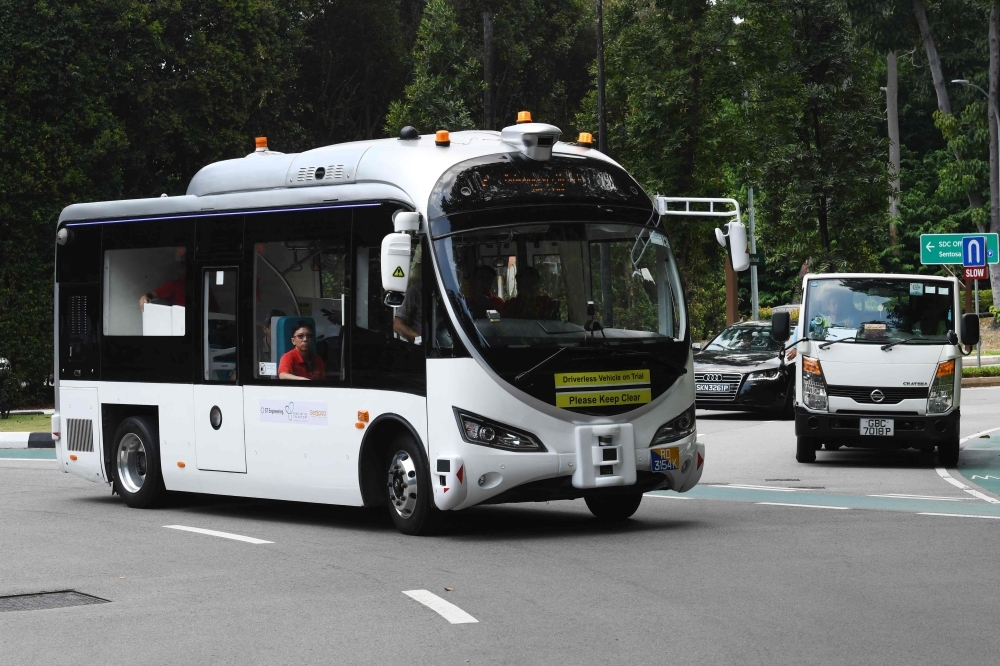 An on-demand autonomous shuttle bus plies the road during the official launch of a public trial run at Sentosa island resort in Singapore on Tuesday. -AFP