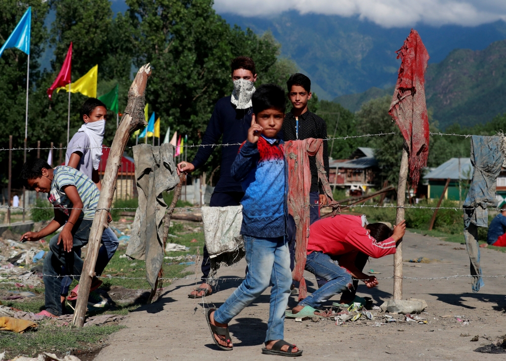Kashmiri protesters on Monday stand at a barricade to block the entrance of a neighborhood in Srinagar, during restrictions after the scrapping of the special constitutional status for Kashmir by the government. — Reuters