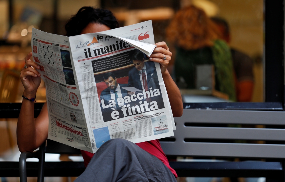 A woman reads a newspaper with news of government crisis and the resignation of the prime minister Giuseppe Conte, in Rome, Italy, on Wednesday. — Reuters