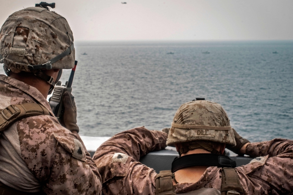 US sailors aboard an amphibious transport dock ship keep watch on Iranian fast inland attack crafts in the Strait of Hormuz in this Aug. 12, 2019 file photo. — AFP