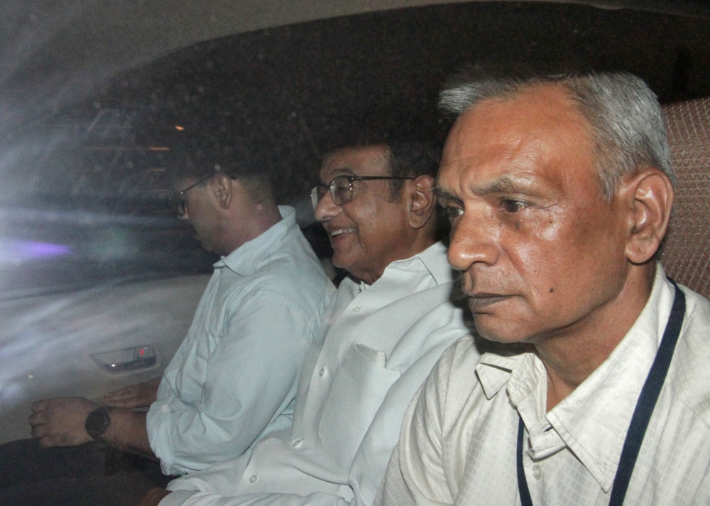 India's former Finance Minister Palaniappan Chidambaram, center, sits in a vehicle after he was arrested by the Central Bureau of Investigation (CBI) officials in his residence in New Delhi, India, on Wednesday. — Reuters