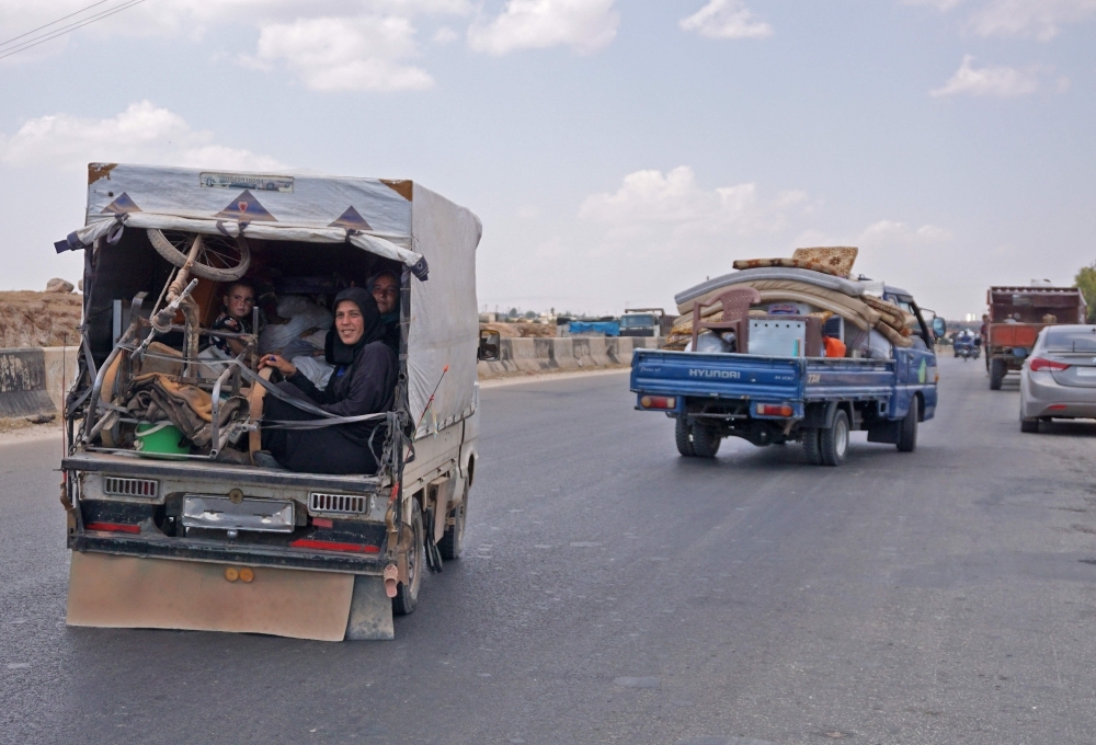 Syrians fleeing from the town of Maaret Al-Numan and its surrounding countryside drive with their belongings northwards near the town of Saraqib in the northwestern Idlib province on Thursday as they flee from the advancing Syrian government and allied forces.  — AFP