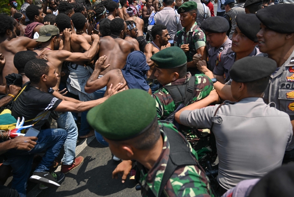 Papuan students taking part in a rally push toward a line of police and military blocking them in front of the army's headquarters in Jakarta on Thursday, as riots and demonstrations have brought several cities in Indonesia's eastern province of Papua to a standstill this week. — AFP