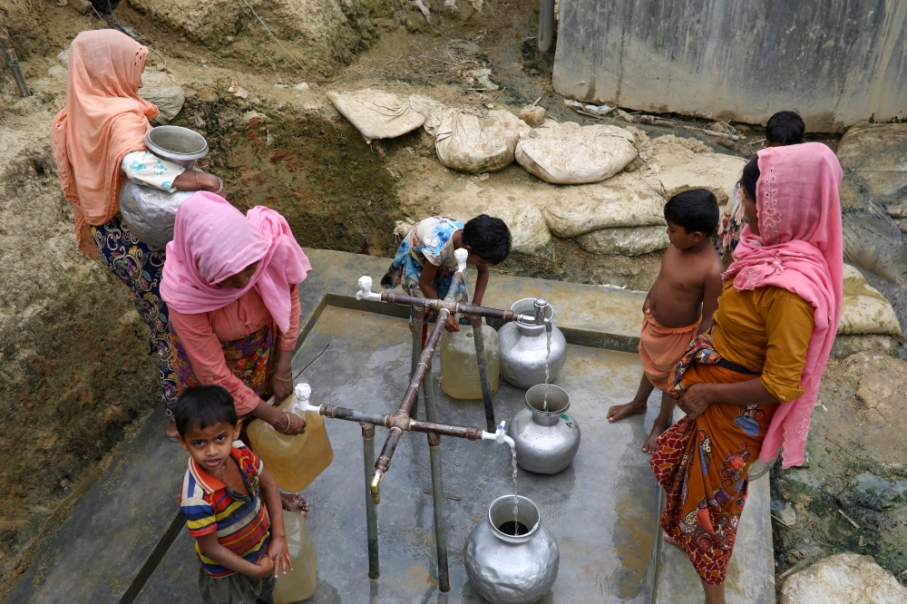Rohingya refugees collect drinking water at the Shalbagan refugee camp in Teknaf, Bangladesh, in this March 5, 2019 file photo. — Reuters