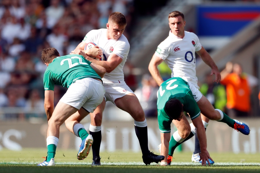 England's Owen Farrell in action with Ireland's Jack Carty at Twickenham Stadium, London, Britain, on Saturday. — Reuters