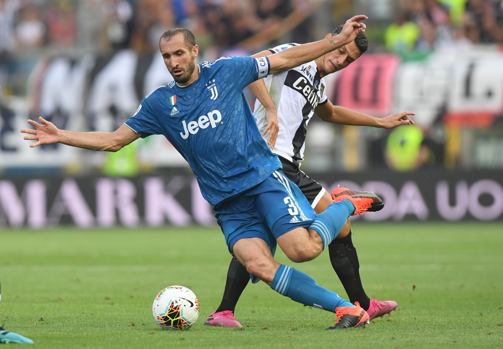 Juventus' Giorgio Chiellini in action with Parma's Roberto Inglese during Serie A match at Stadio Ennio Tardini, Parma, Italy, on Saturday. — Reuters
