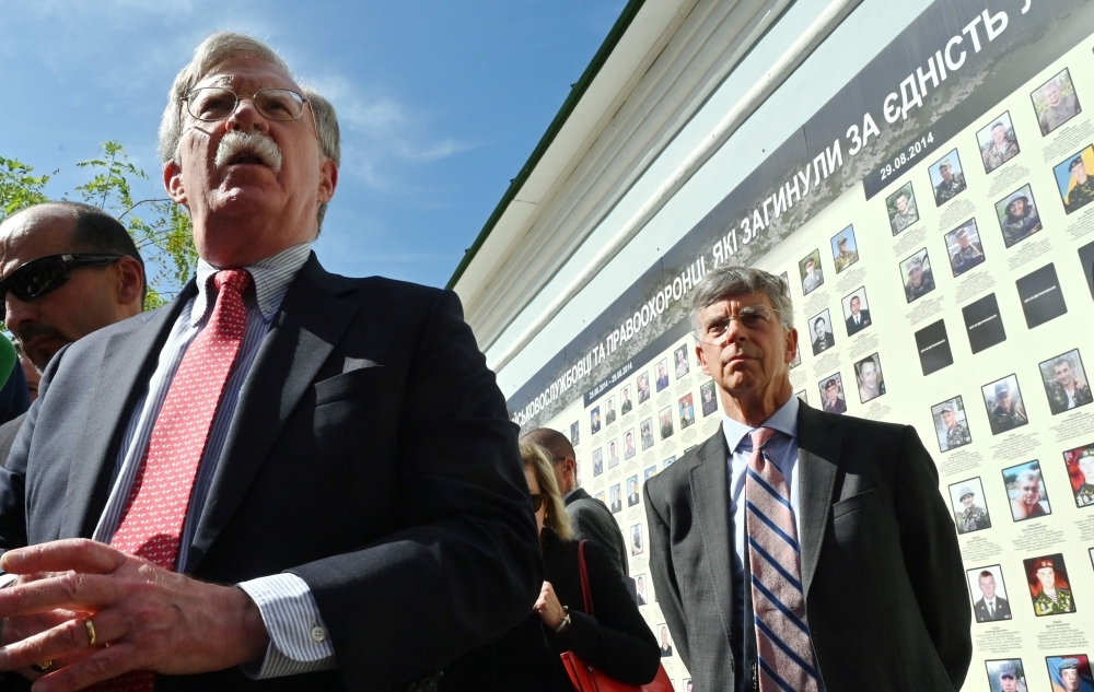 National Security Adviser of the United States John Bolton speaks to the press as US Ambassador to Ukraine William Taylor, right, listens on at a memorial for those killed in the war against Russia-backed separatists in the Donbass region during ceremony in Kiev on Tuesday. — AFP