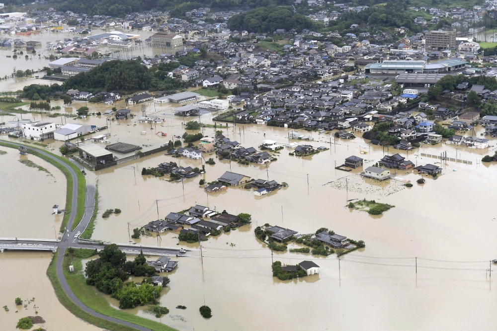 An aerial view shows submerged houses and facilities at a flooded area in Takeo, Saga prefecture, southern Japan on Wednesday. -Reuters