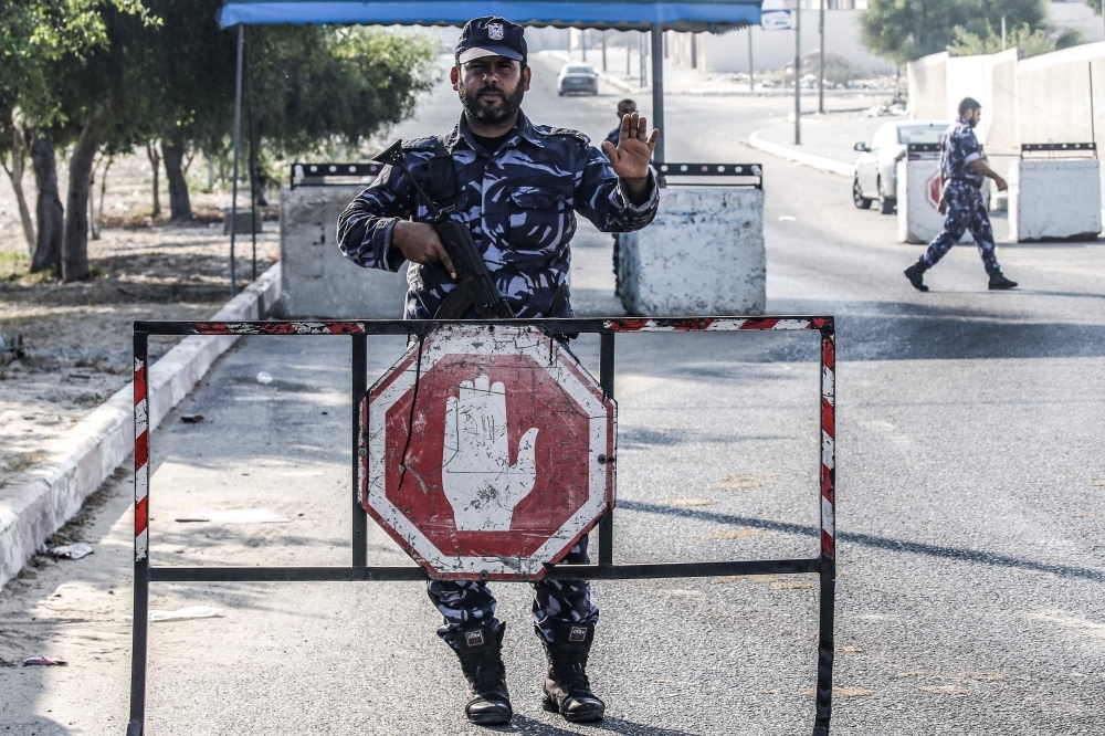 Security forces loyal to Palestinian Islamist movement Hamas man a checkpoint and stop vehicles for checks in Khan Yunis in the southern Gaza Strip on Wednesday. -AFP 