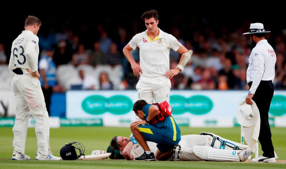 Australia's Steve Smith receives treatment as he lays on the floor after being hit by a ball from England's Jofra Archer as England's Jos Buttler and Australia's Pat Cummins look on during the Ashes 2019 second Test at the Lord's Cricket Ground, London, Britain.  — Reuters