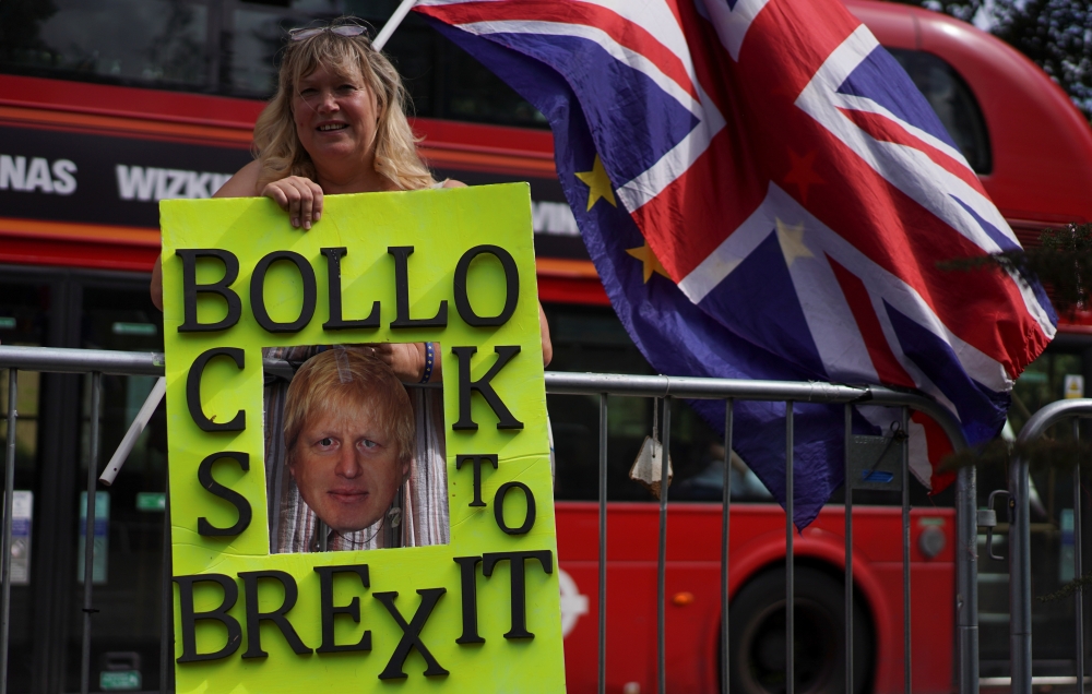 An anti-Brexit protestor holds a placard outside parliament in London, Wednesday. — Reuters