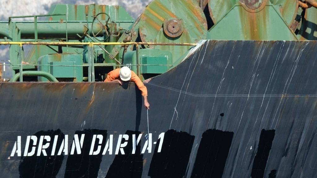 A crew member checks the new name of Iranian oil tanker Adrian Darya, formerly known as Grace 1, off the coast of Gibraltar in this Aug. 18, 2019 file photo. — AFP