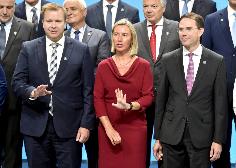 Finnish Minister of Defense Antti Kaikkonen, left, EU foreign policy chief Federica Mogherini and European Commission Vice President and commissioner for Jobs, Growth, Investment and Competitiveness Jyrki Katainen pose for a family photo of the informal meeting of EU defence ministers in Helsinki, Finland, on Thursday. — Reuters