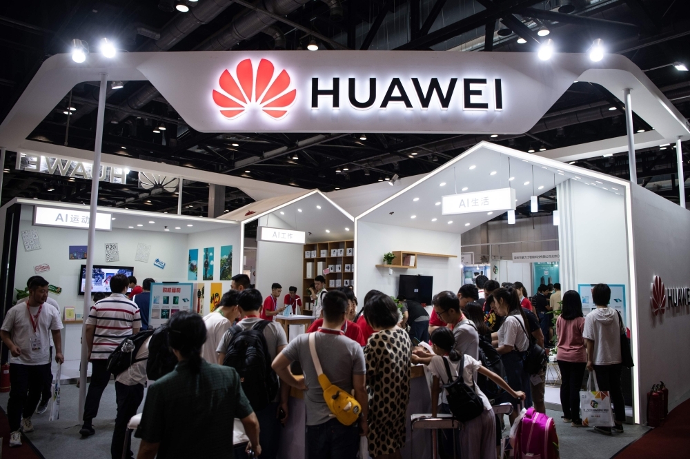 In this file photo, attendees visit a Huawei exhibition stand during the Consumer Electronics Expo in Beijing. Huawei's upcoming flagship Mate 30 smartphone will launch next month without key Google apps, creating a disadvantage for the Chinese tech giant hit by US sanctions. — AFP