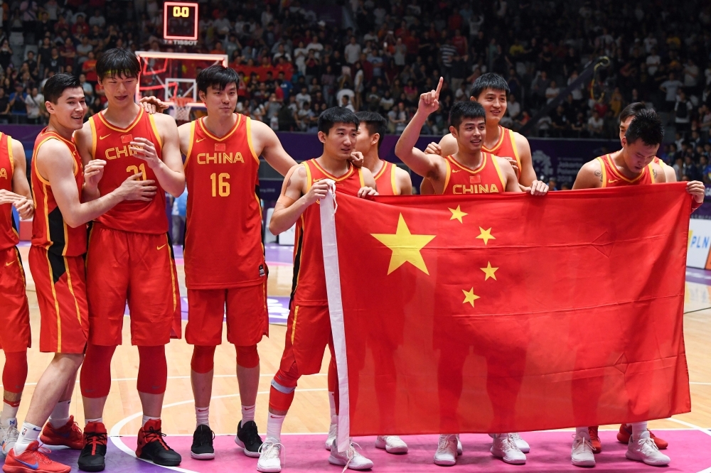 This file photo shows China's players celebrating their victory after the men's gold medal basketball match between Iran and China at the 2018 Asian Games in Jakarta. They're ranked just 30th in the world, but China will have some promising new talent, a gentle group draw, and a billion-plus fans on their side as the hosts look to make some noise at the Basketball World Cup.  — AFP 