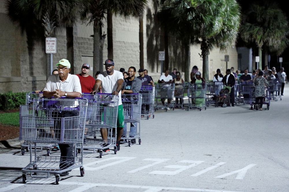 Shoppers wait in a long line for a Sam's Club store to open before sunrise, as people rushed to buy supplies ahead of the arrival of Hurricane Dorian in Kissimmee, Florida, on Friday. — Reuters