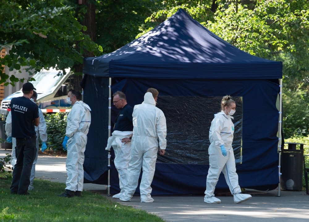 This file photo shows forensic experts of the police securing evidences at the site of a crime scene in Berlin's Moabit district, where a man of Georgian origin was shot dead. German media, among them the weekly Der Spiegel magazine published on Saturday, suppose an involvement of Russia in the assassination-style killing in the Berlin park of the Georgian who had fought against Russian forces in Chechnya. — AFP