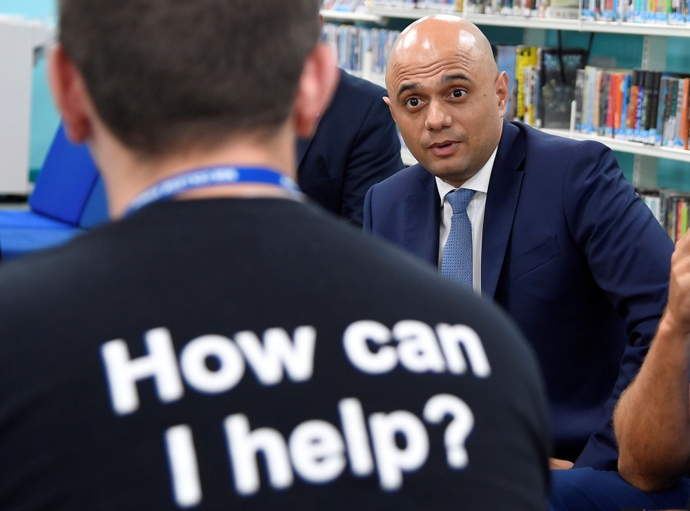 Britain's Chancellor of the Exchequer Sajid Javid speaks with former students during a visit to SGS College Filton, where Javid himself studied, in Bristol, Britain, on Friday. — Reuters