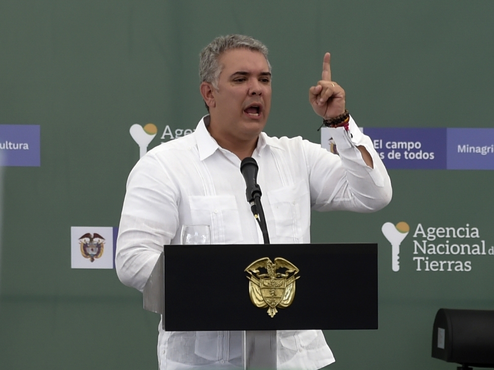 Colombian President Ivan Duque gestures as he speaks during an event to give land property deeds to conflict victims in Ovejas, northern Colombia, on Friday.  Colombian troops killed nine FARC dissidents in a raid Friday in what the president said was 