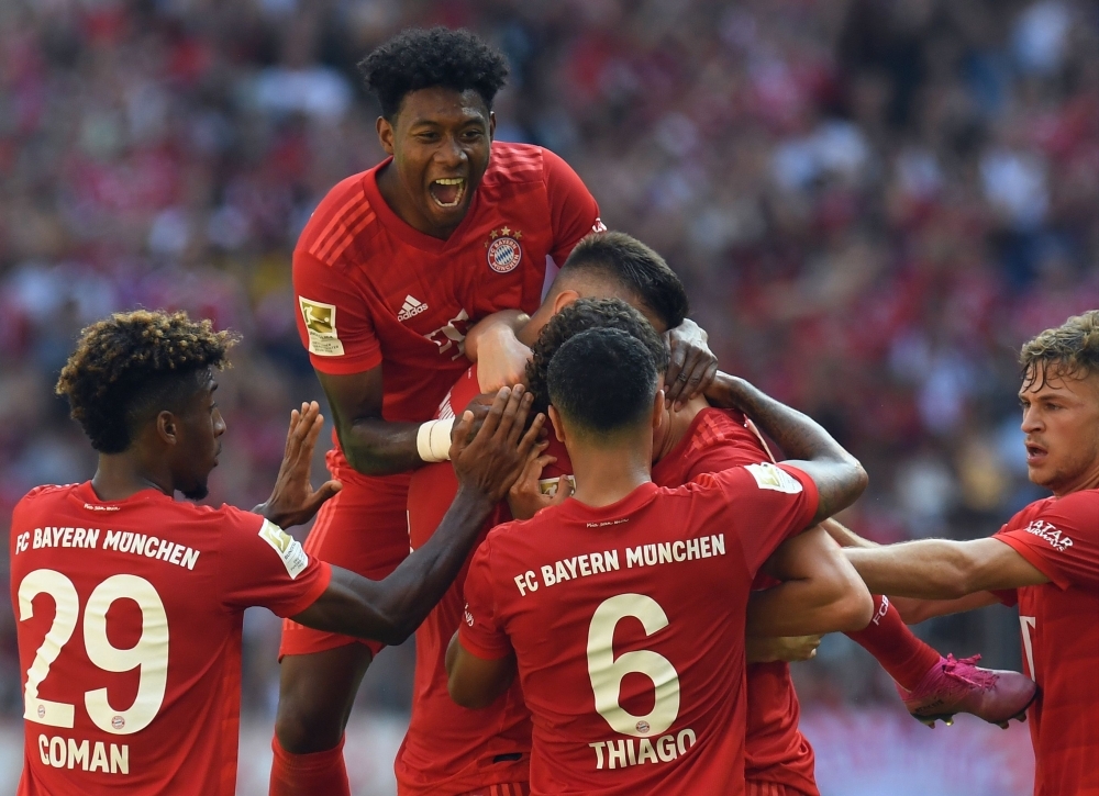 (L-R) Bayern Munich's French defender Kingsley Coman, Austrian defender David Alaba, defender Niklas Suele, French defender Benjamin Pavard, Spanish midfielder Thiago Alcantara and midfielder Joshua Kimmich celebrate after their first goal during the German Bundesliga football match against Mainz 05 in Munich on Saturday.  — AFP 